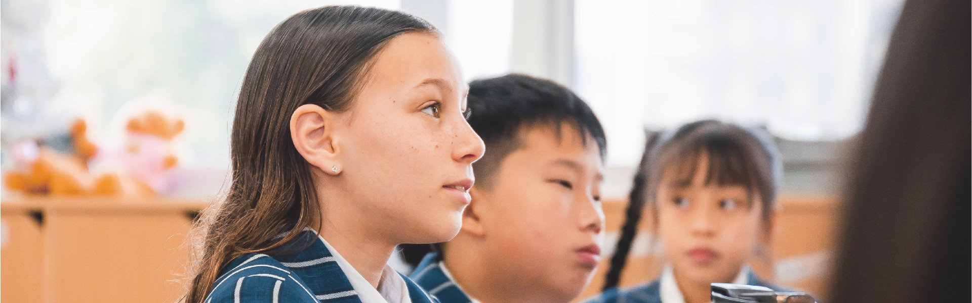Middle school students at LUYA Academy listening attentively in class